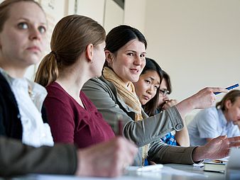 Audience in a full seminar room.