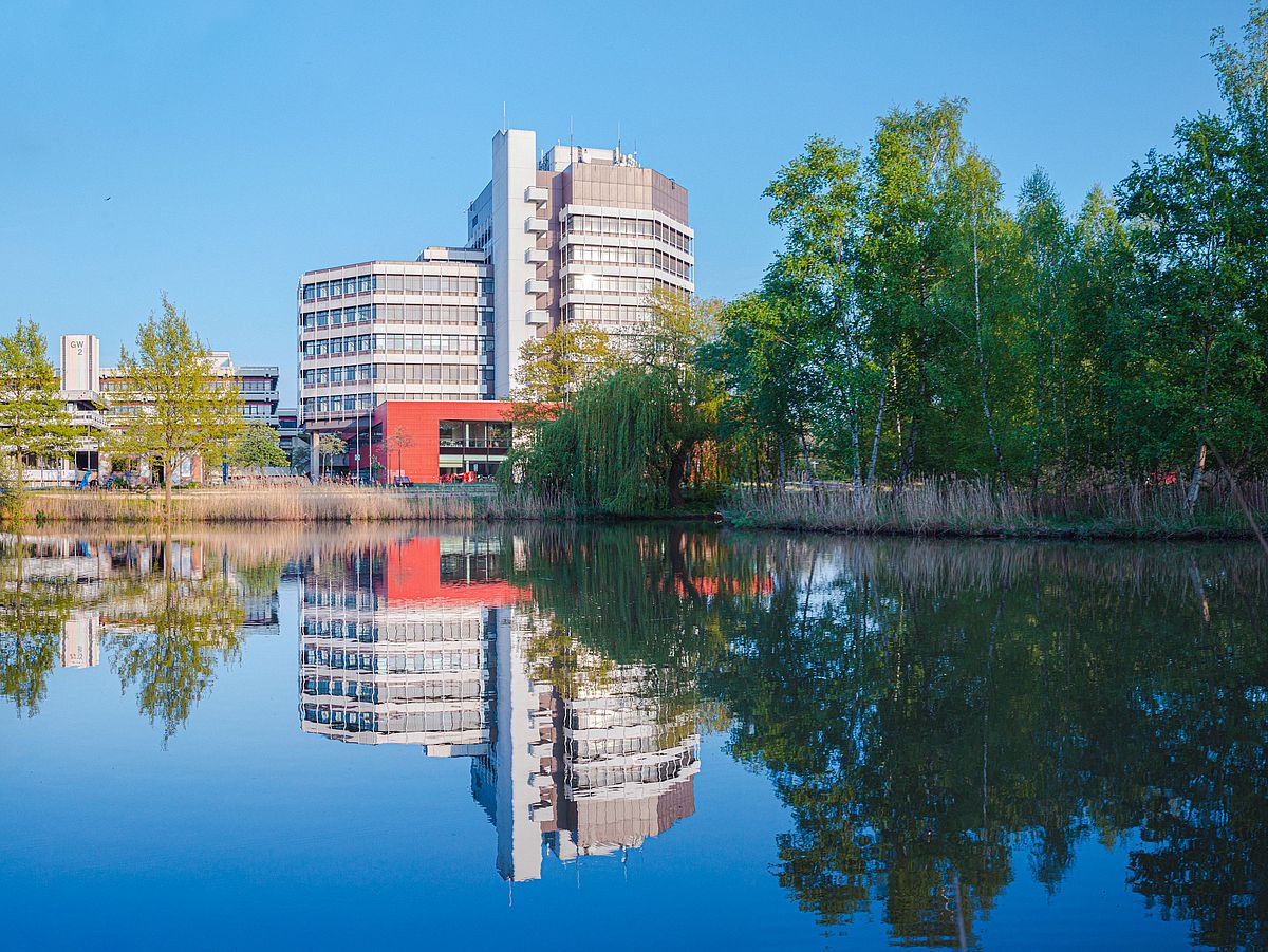 The MZH reflected in a lake in Campus Park.
